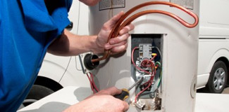 one of our pros is inspecting a water heater unit
